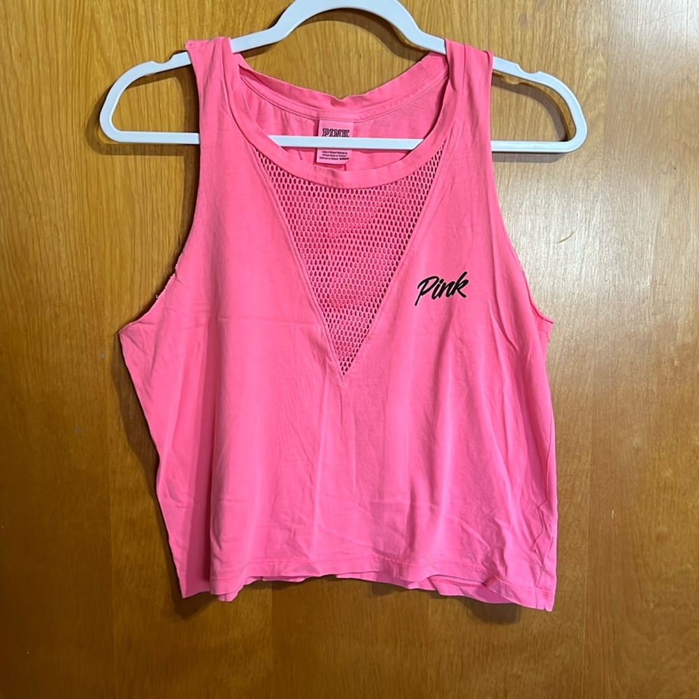 Cropped tank top with fish net cutout in the front.